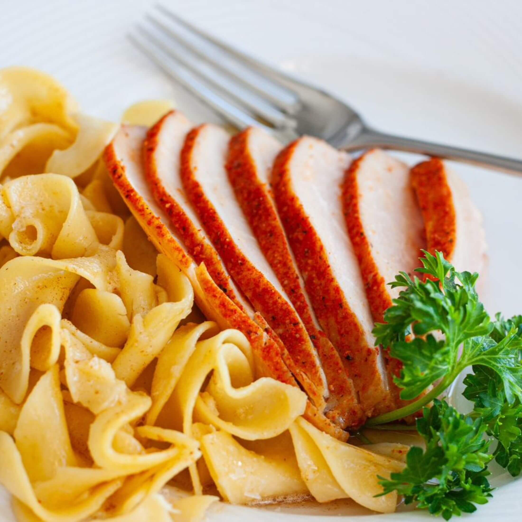 Sliced Pork Tenderloin Plated with egg noodles