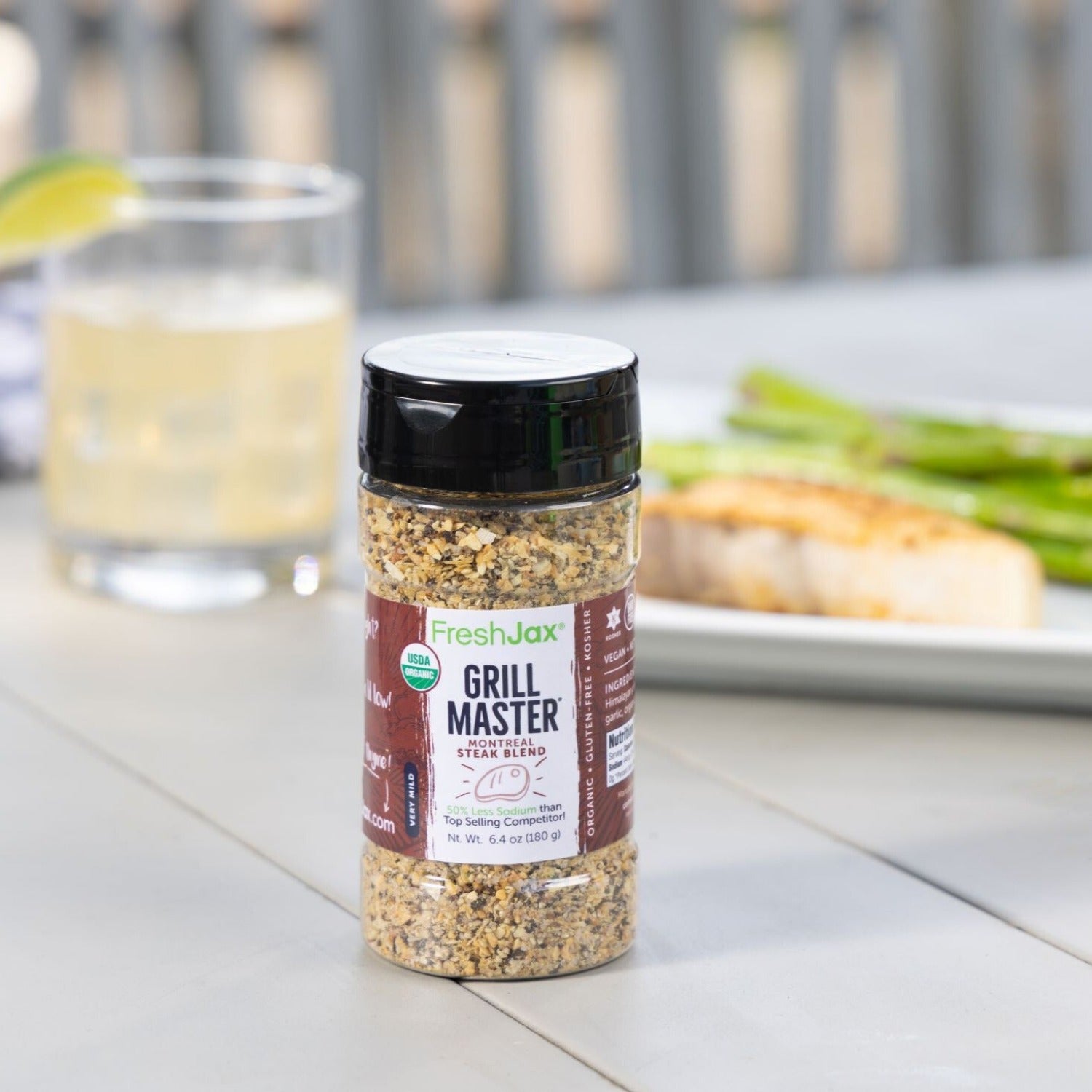 Grill Master Steak Seasoning next to salmon, asparagus, and a beverage