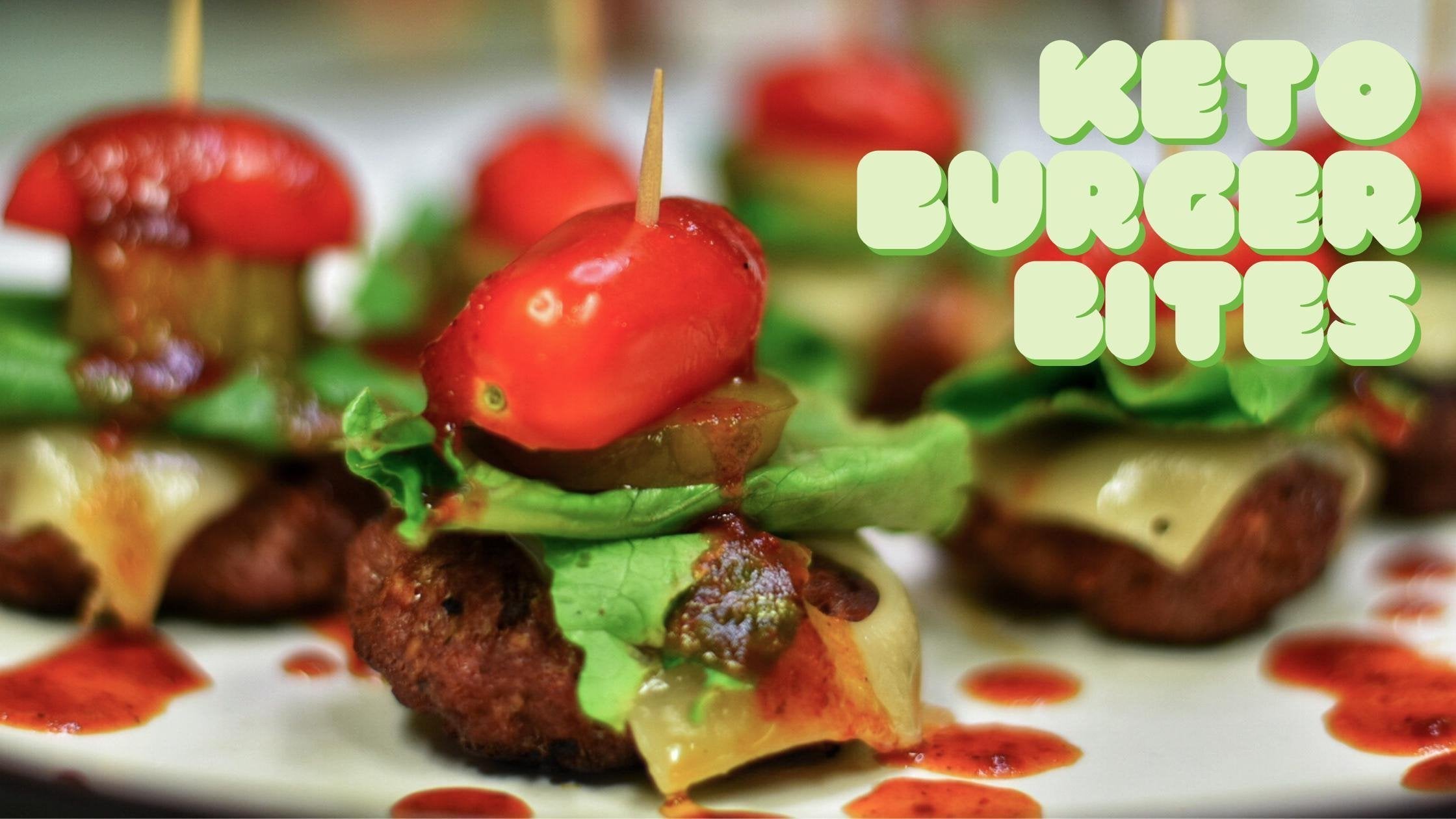 Keto burger bites on mini skewers with burger patty, tomatoes, pickles, lettuce, cheese, and sauce.