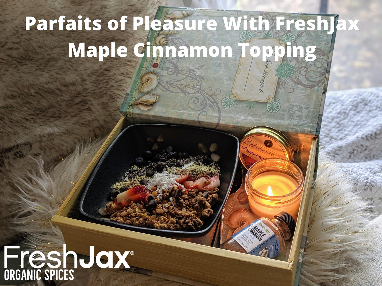 A mother's day parfaits of pleasure gift basket with a bowl of maple cinnamon parfait next to a bottle of FreshJax maple cinnamon topping and lit peppermint bark candle.