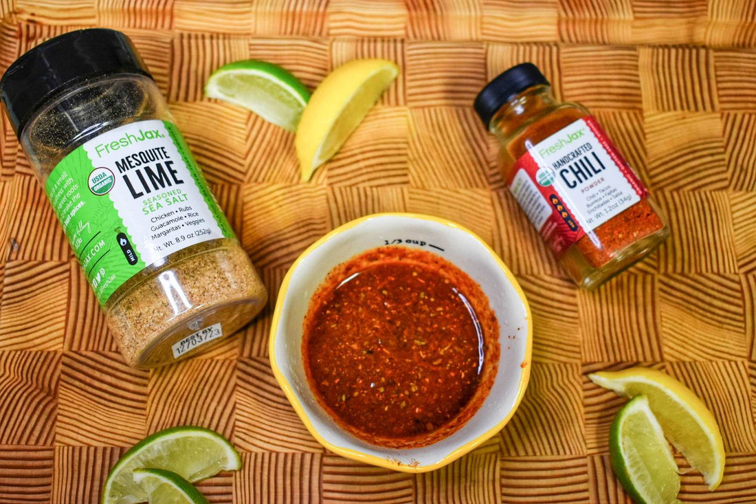 FreshJax Organic Mesquite Lime Seasoned Sea Salt and handcrafted chili powder with lime wedges