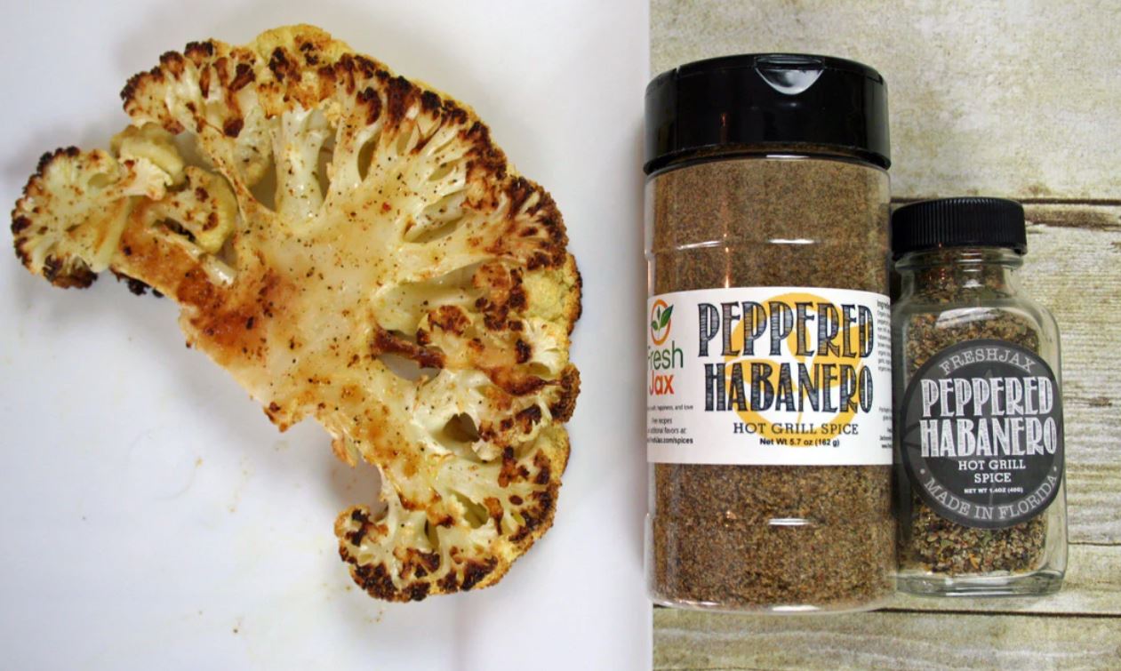 Grilled Cauliflower Steak next to two bottles of FreshJax Peppered Habanero