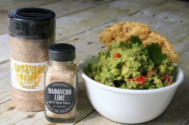 Guacamole, Tortilla Chips, and two bottles of FreshJax Habanero Lime Seasoning