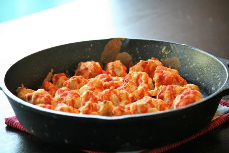 Skillet full of Spicy Buffalo Caulifower