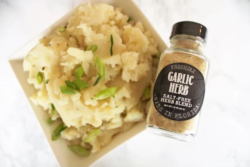 bowl of mashed potatoes with garlic herb seasoning