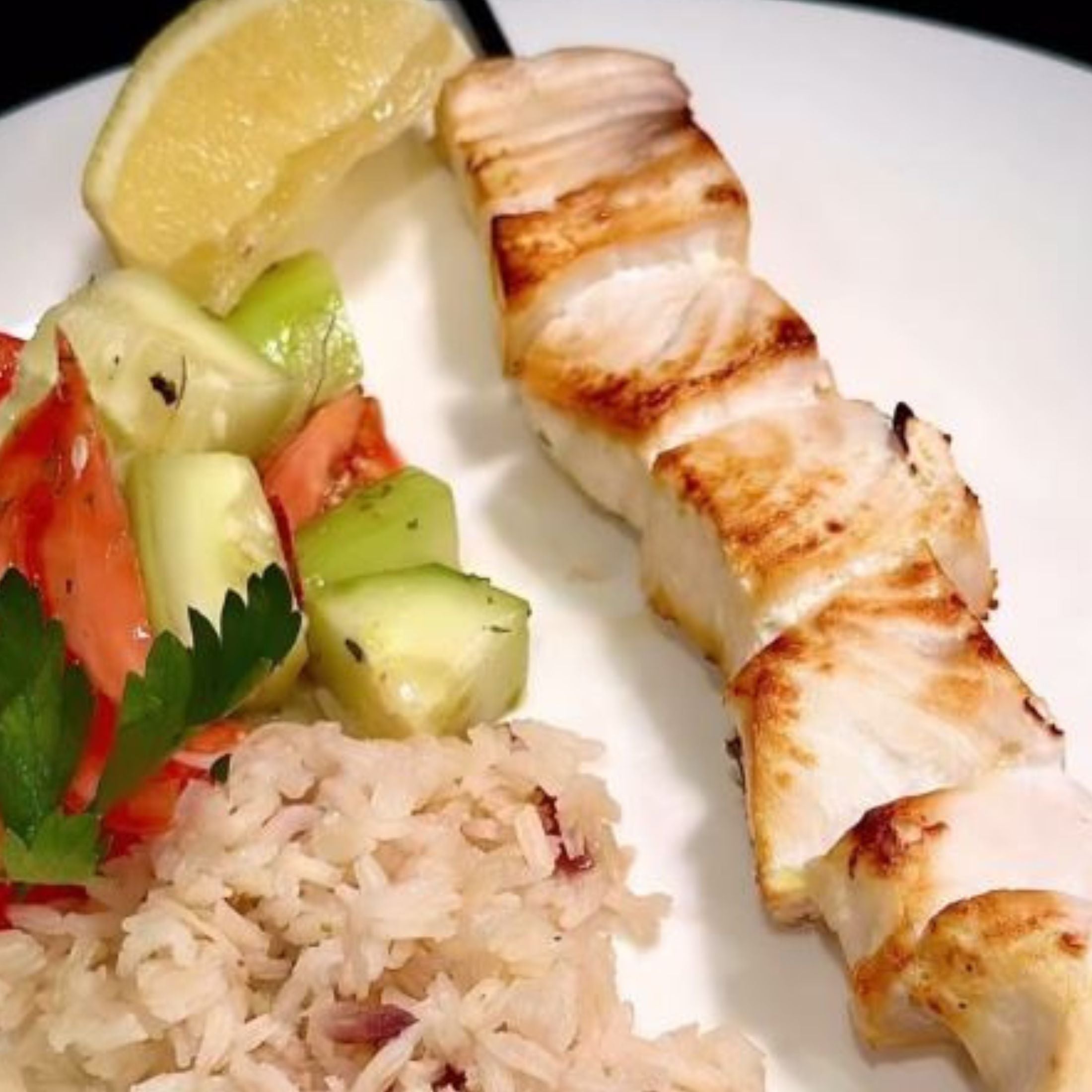 Swordfish Kebabs seasoned with Greek Seasoning with rice and a small salad