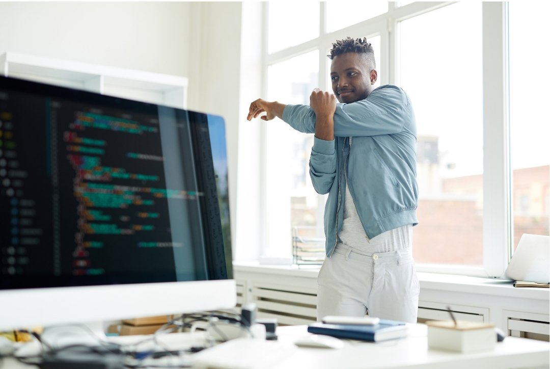 man stretching in office