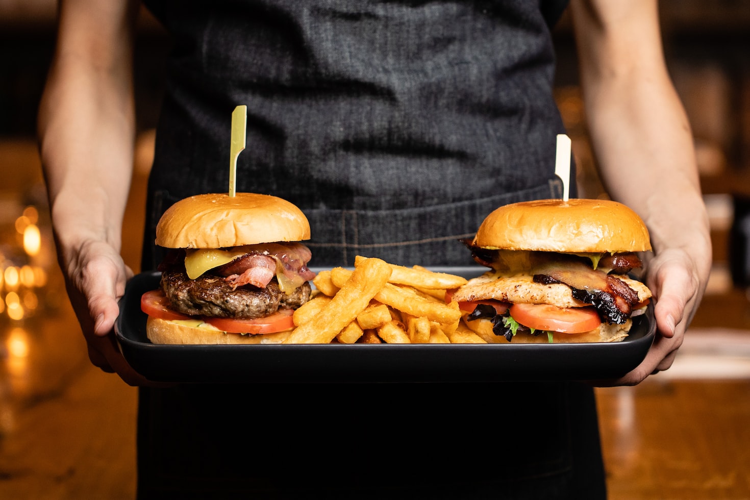 Burgers with buns and fries on a tray