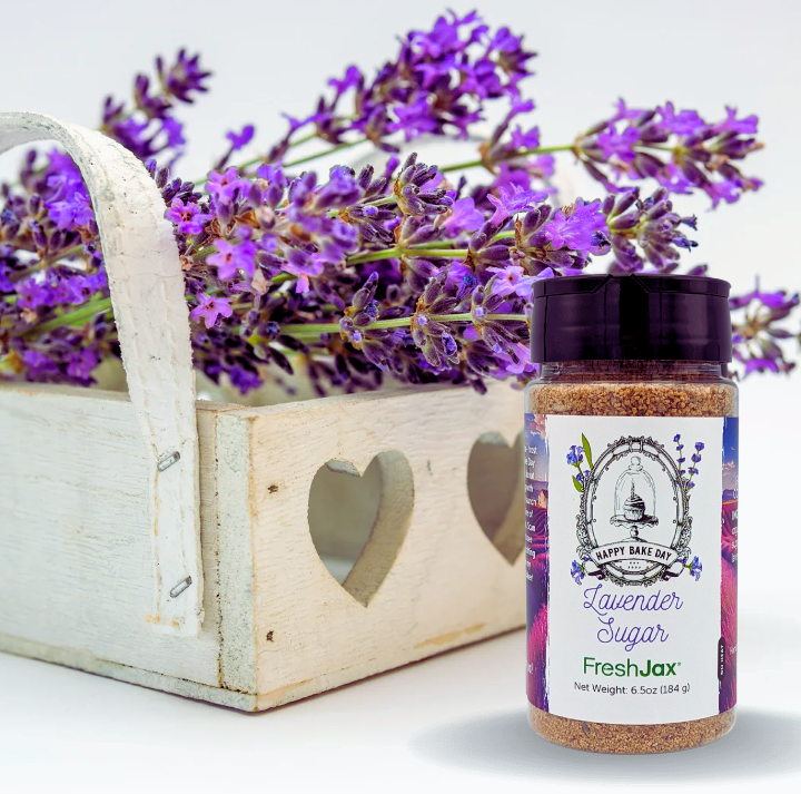 FreshJax Lavender Sugar bottle next to a basket of Lavender Flowers