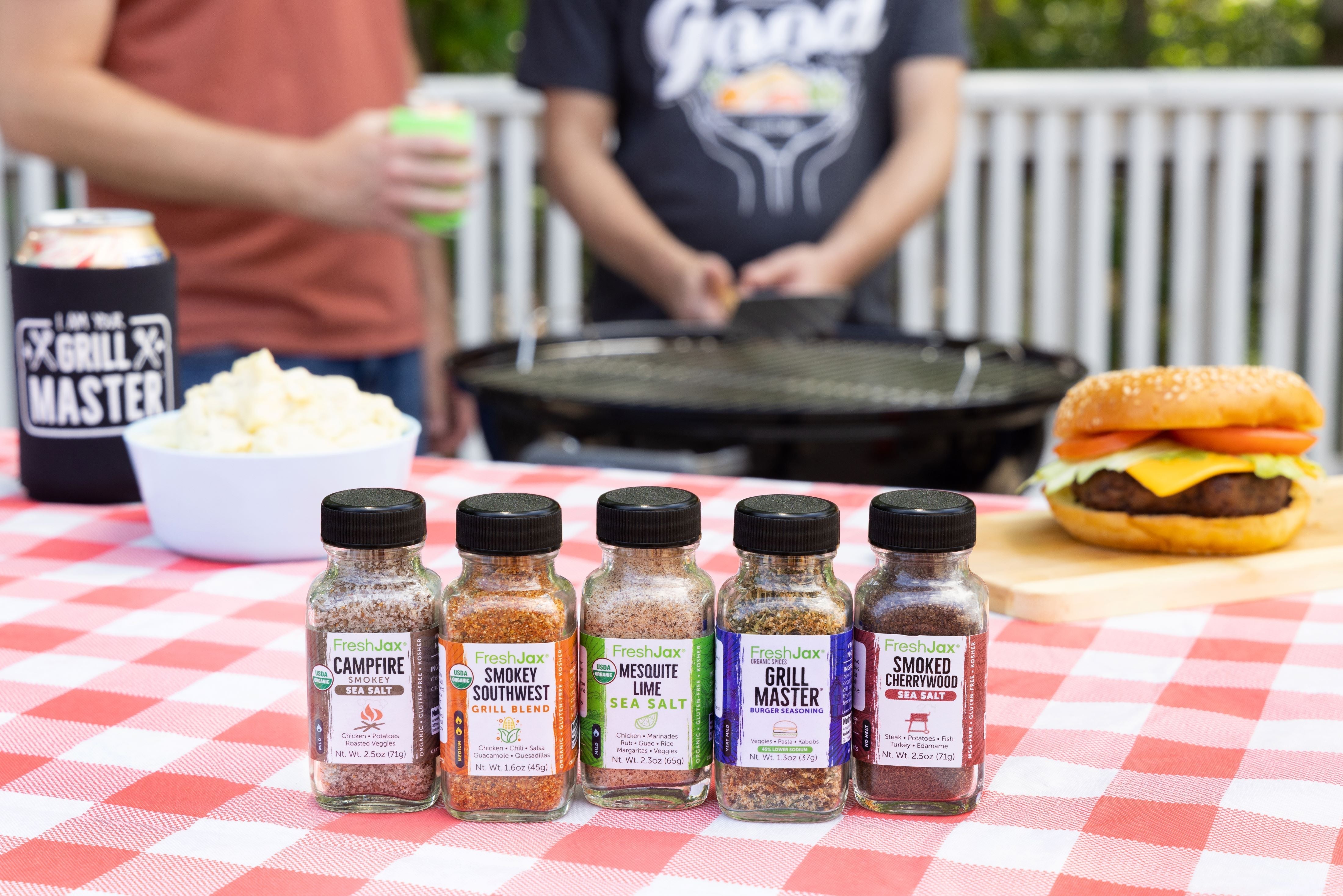 Two Dudes by a grill with FreshJax Smoked Seasonings 5 Pack