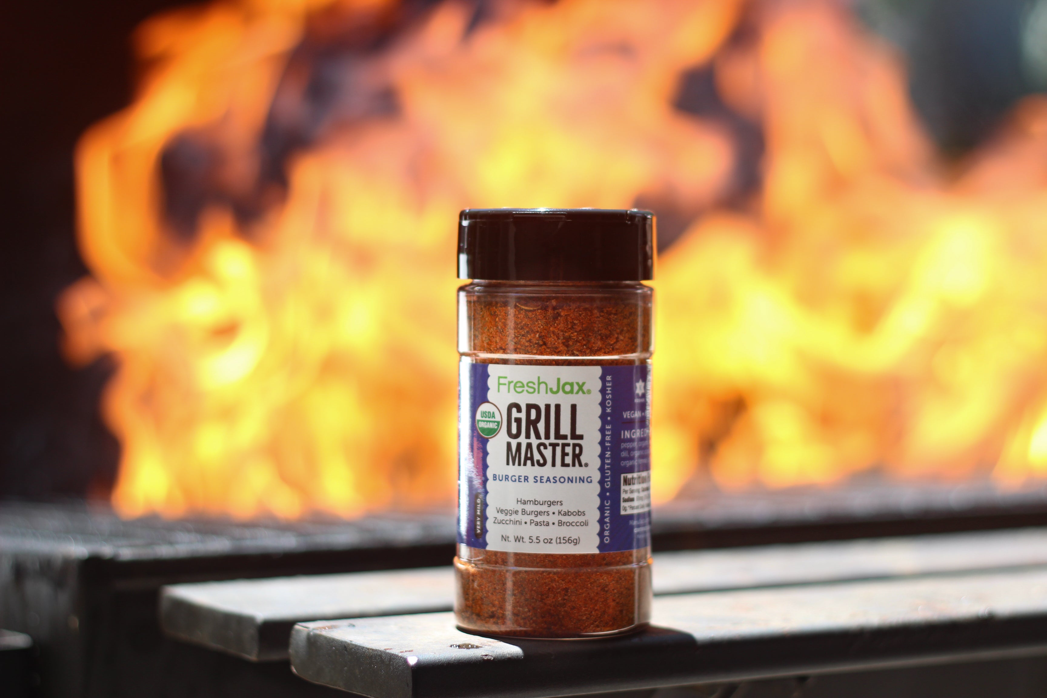 Bottle Of Grill Master Burger Seasoning Near an Open BBQ