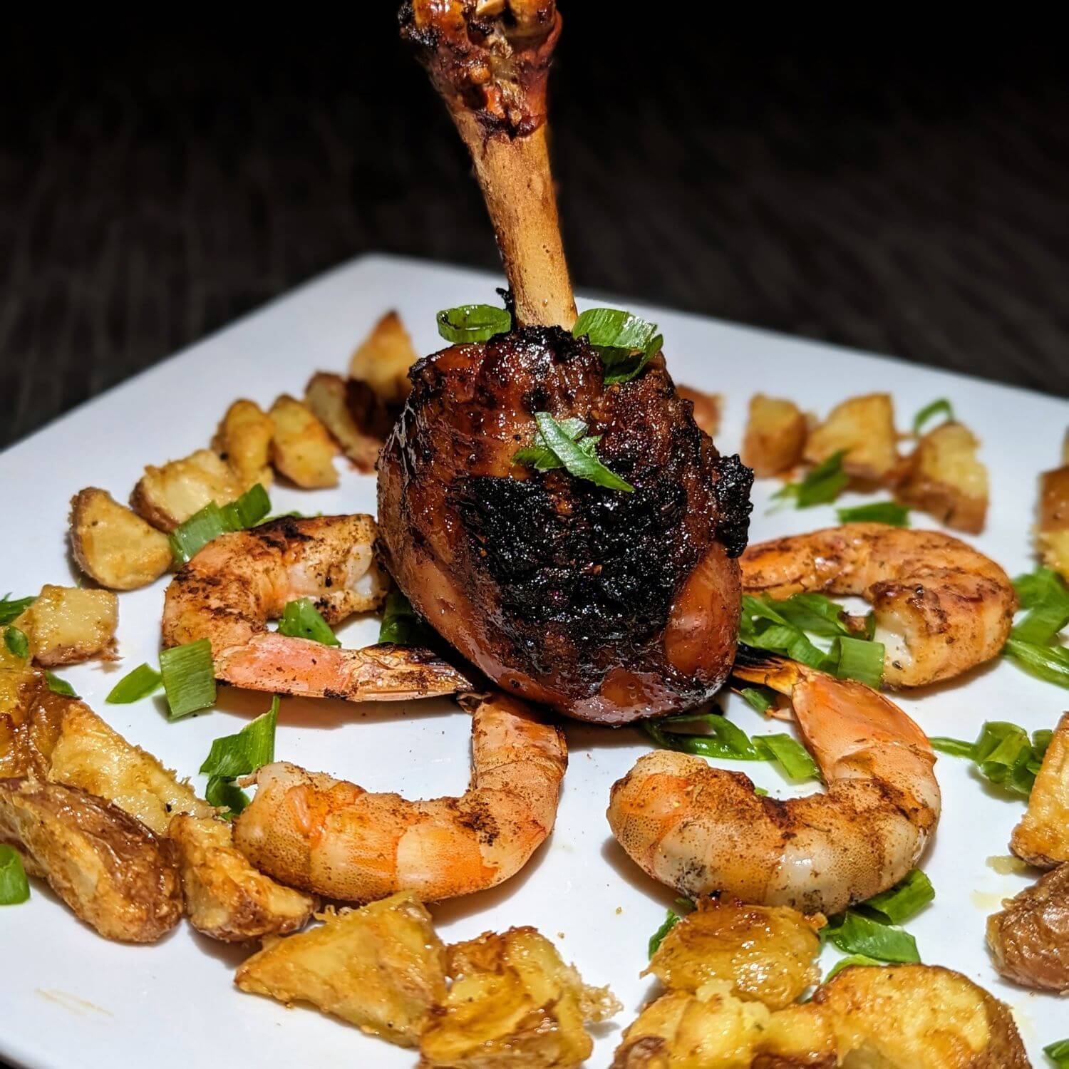 Chicken Lollipops on a plate with grilled shrimp