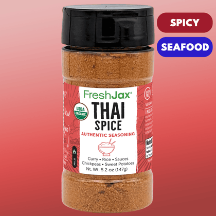 Large Bottle of FreshJax Thai Spice seasoning with a red label on a pink background