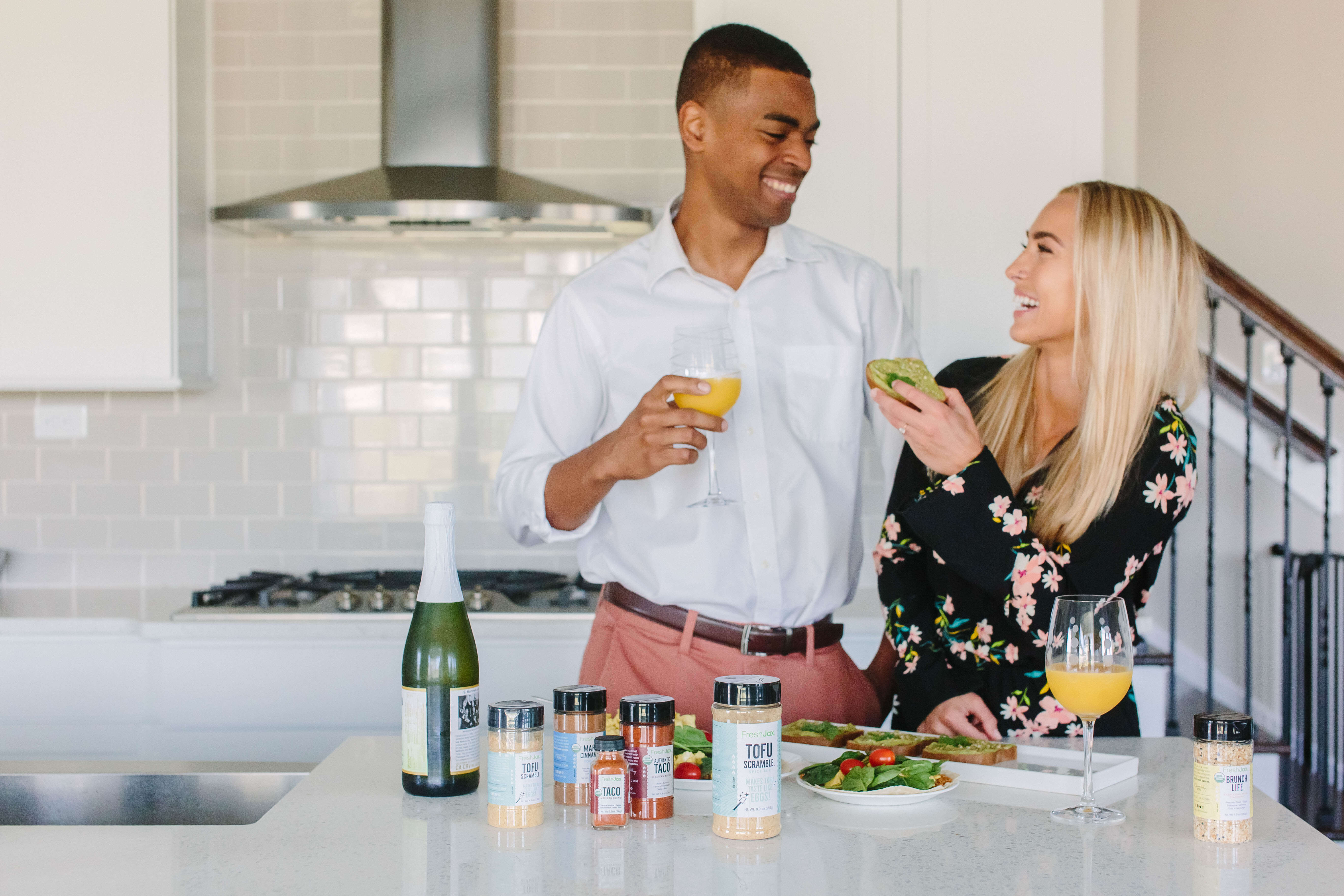Young Couple eating brunch with Avocado Toast and Mimosas