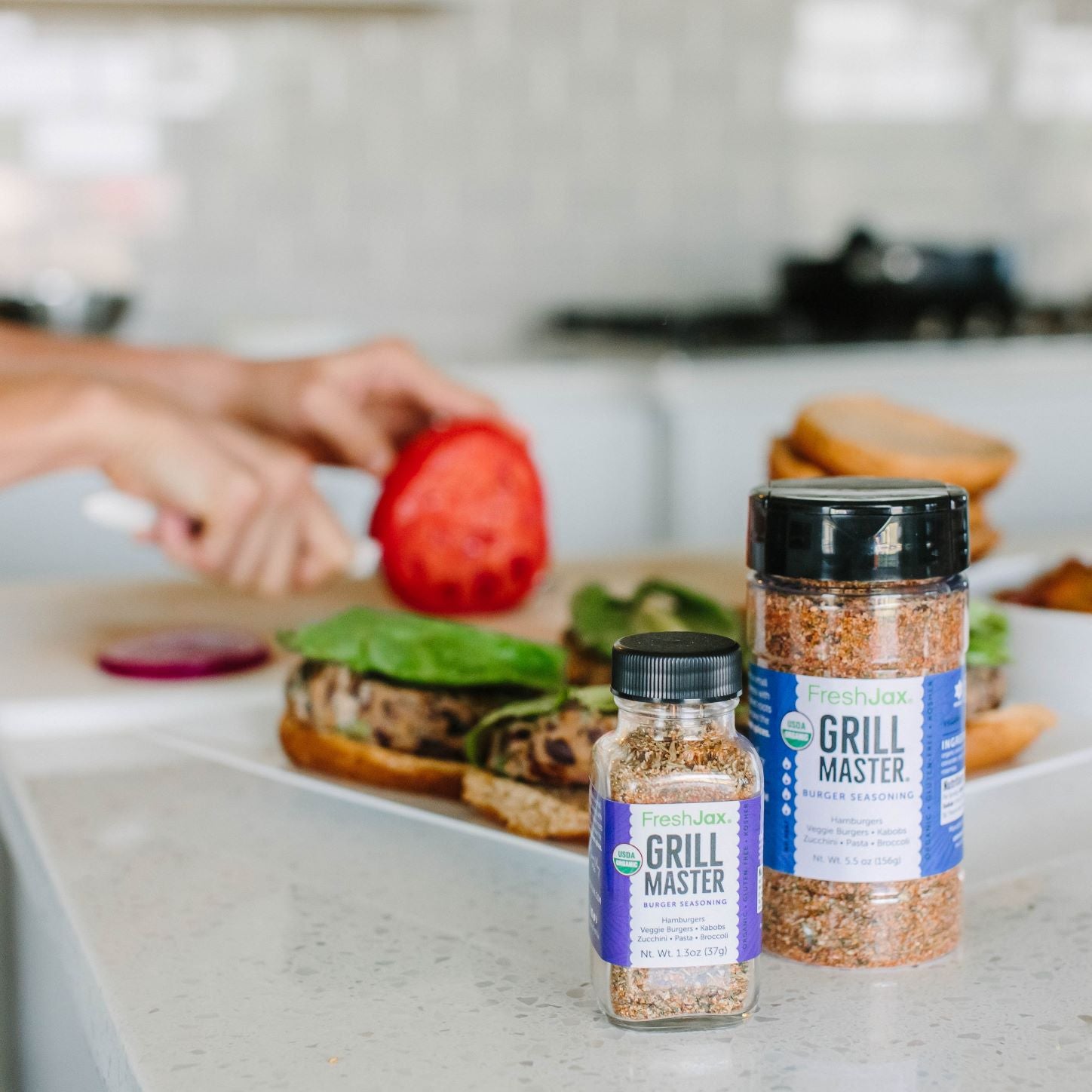 Making Veggie Burgers in the kitchen next to a large and sampler sized bottle of FreshJax Grill Master Burger Seasoning